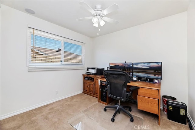 carpeted office featuring ceiling fan