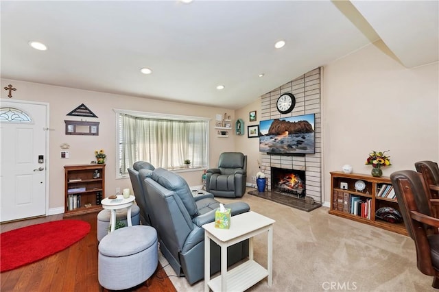 carpeted living room with lofted ceiling and a fireplace