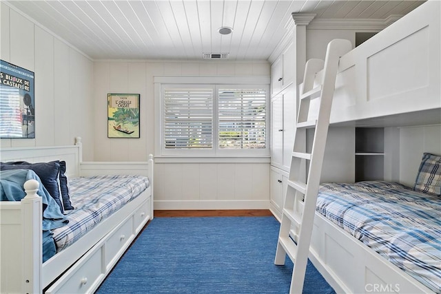 bedroom with dark hardwood / wood-style flooring, multiple windows, crown molding, and wood ceiling