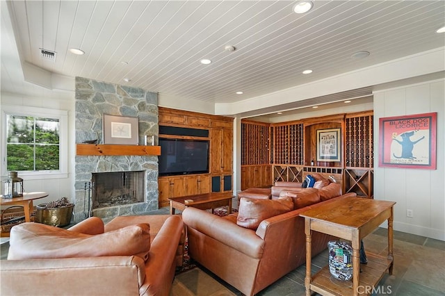 living room featuring a fireplace and wooden ceiling