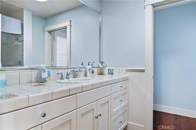 bathroom with wood-type flooring and vanity