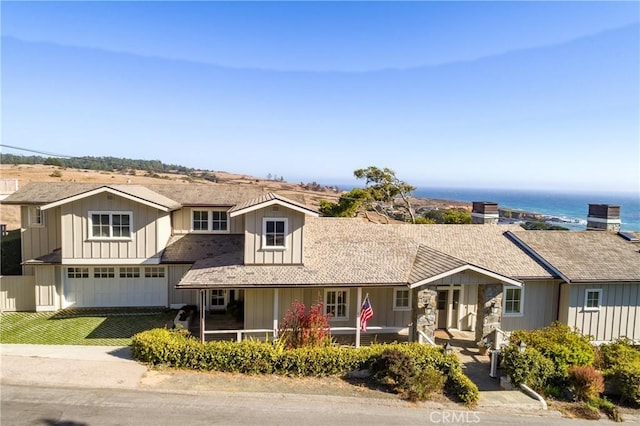 view of front facade with a garage and a water view