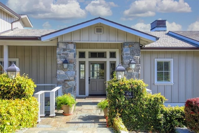 property entrance featuring board and batten siding and a chimney