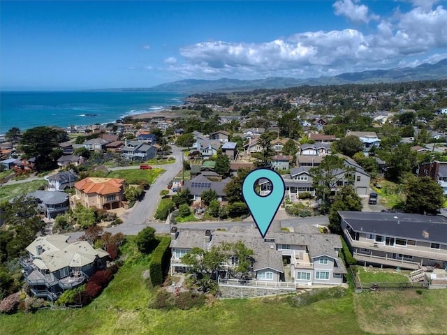 birds eye view of property with a water and mountain view and a residential view