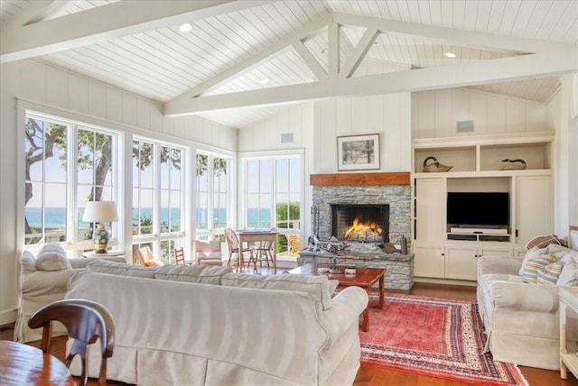 living room with plenty of natural light, dark wood-style floors, and vaulted ceiling with beams