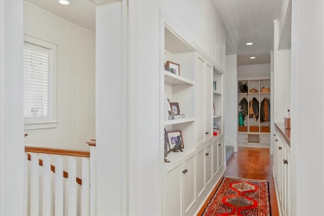 hallway featuring recessed lighting, built in shelves, and dark wood finished floors
