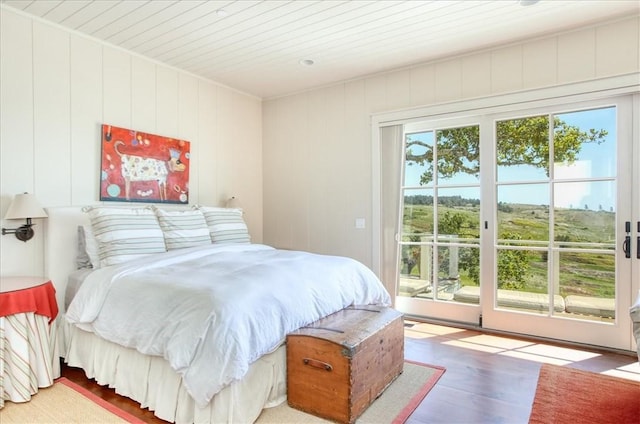 bedroom featuring access to outside, wood finished floors, and wooden ceiling