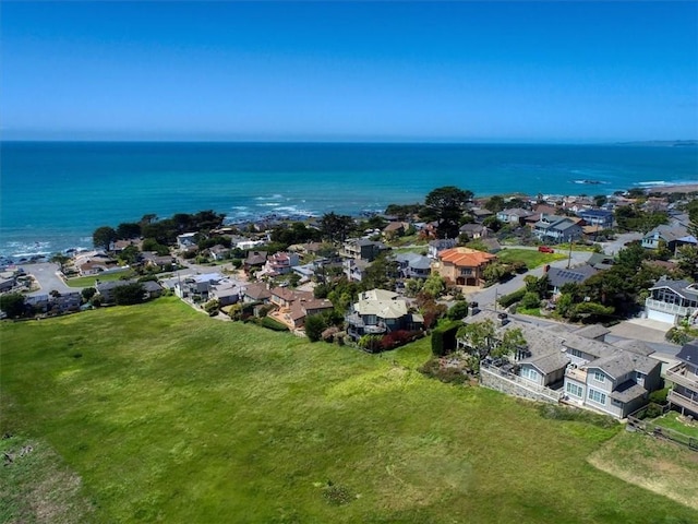 drone / aerial view featuring a water view and a residential view