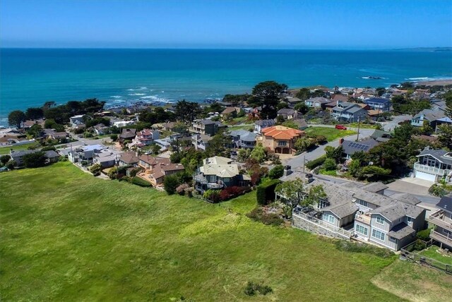drone / aerial view with a residential view and a water view