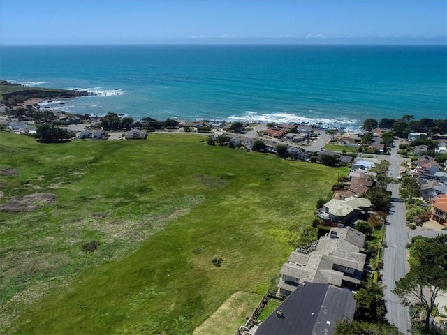 bird's eye view featuring a view of the beach, a residential view, and a water view