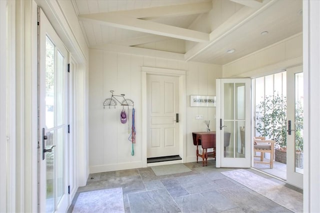 interior space featuring french doors, beamed ceiling, and plenty of natural light
