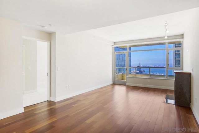 unfurnished room featuring dark hardwood / wood-style flooring