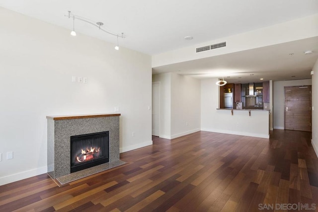 unfurnished living room featuring dark wood-type flooring