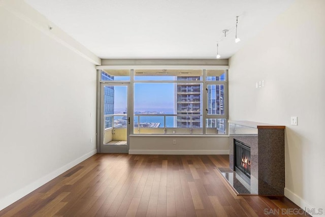 interior space featuring dark hardwood / wood-style flooring and a water view