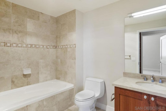 bathroom featuring vanity, tiled bath, and toilet