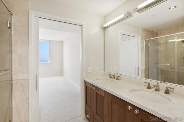 bathroom featuring vanity and an enclosed shower