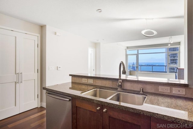 kitchen featuring dishwasher, dark hardwood / wood-style flooring, a water view, and sink