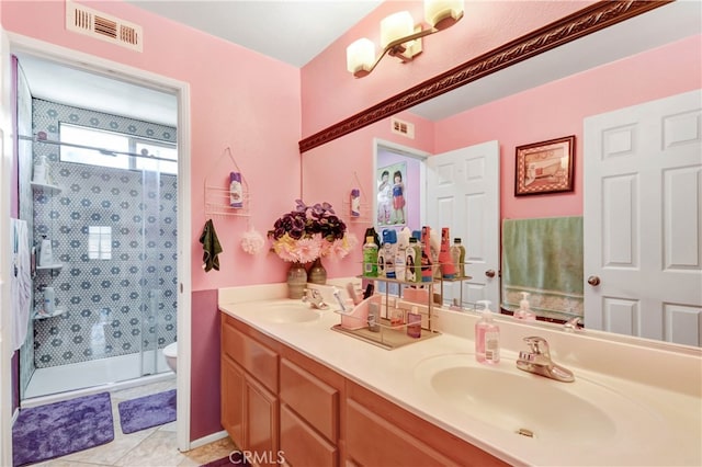 bathroom with vanity, a shower with shower door, toilet, and tile patterned floors