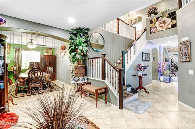 stairs with ceiling fan and tile patterned floors