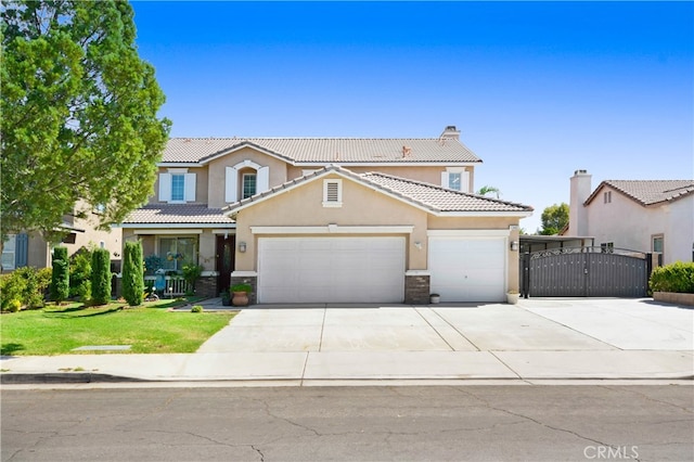 view of front of property with a front yard and a garage