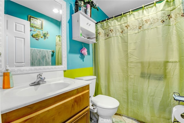 bathroom featuring tile patterned flooring, vanity, and toilet