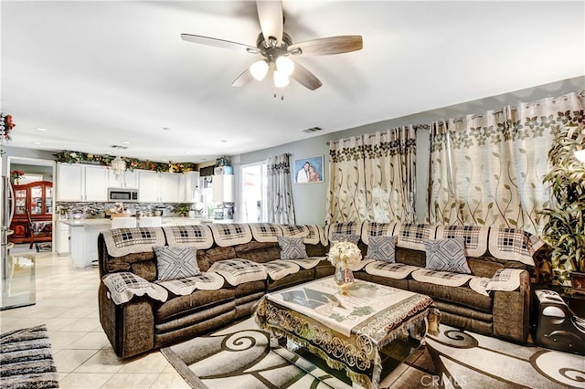 tiled living room with ceiling fan