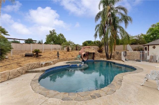 view of pool featuring an in ground hot tub and a patio