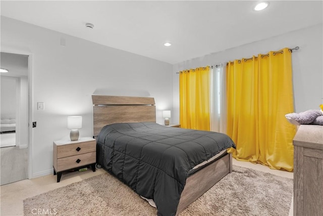 bedroom featuring light carpet