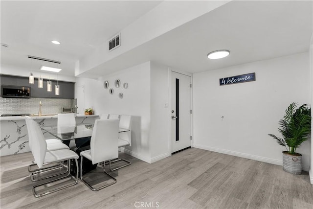 dining area with light hardwood / wood-style flooring