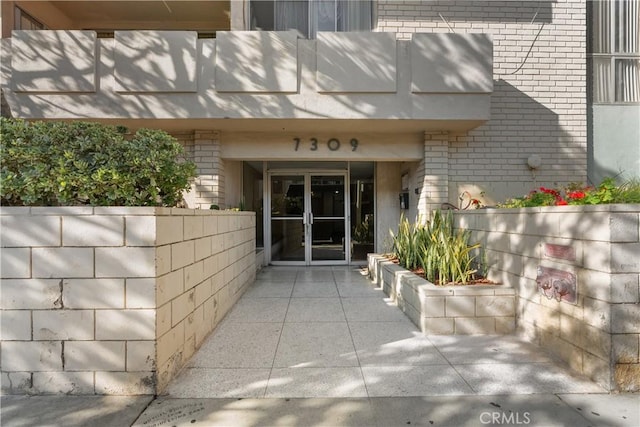 doorway to property with a patio