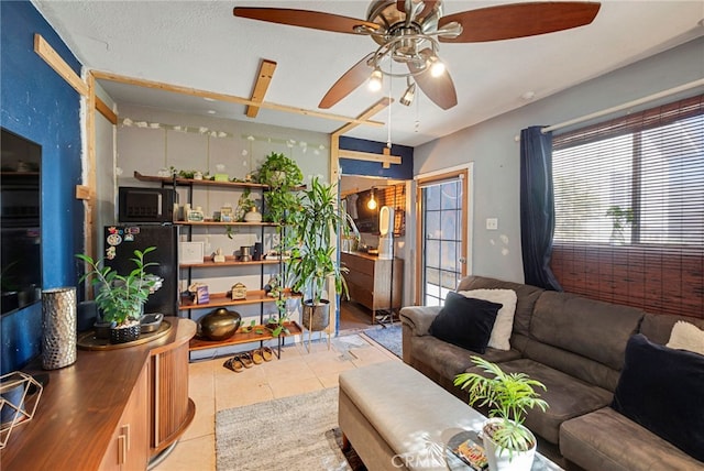 living room with light tile patterned flooring and a textured ceiling