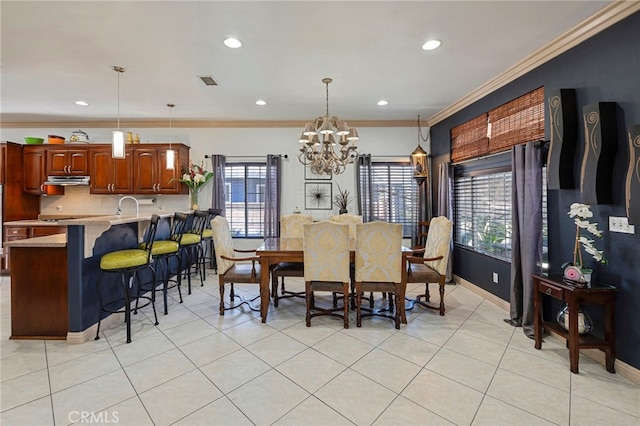 dining room with light tile patterned floors, an inviting chandelier, and crown molding