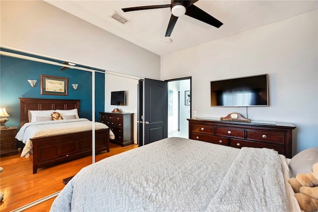 bedroom featuring ceiling fan, vaulted ceiling, and light hardwood / wood-style flooring