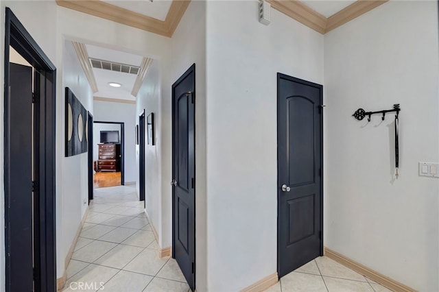 corridor featuring ornamental molding and light tile patterned floors