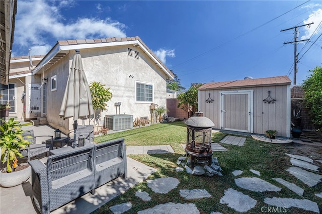 view of yard featuring a patio area, a storage unit, and cooling unit