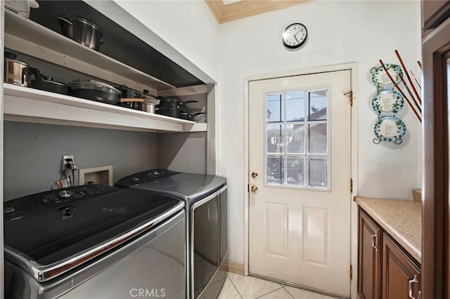 laundry area with light tile patterned flooring and washer and dryer