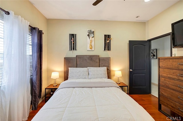 bedroom featuring ceiling fan and dark hardwood / wood-style flooring