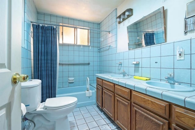 full bathroom with vanity, toilet, shower / bathtub combination with curtain, tile walls, and tile patterned flooring