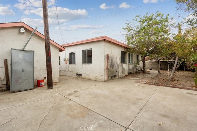 view of side of property with a patio area