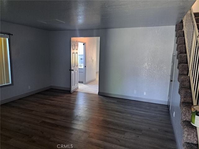 unfurnished room featuring dark hardwood / wood-style floors