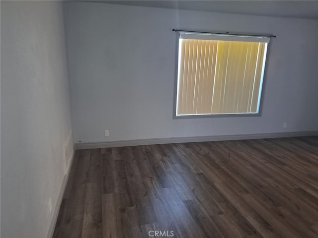 spare room with dark hardwood / wood-style flooring