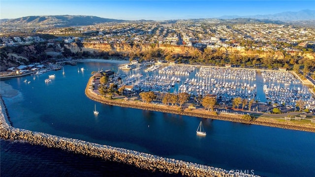 drone / aerial view with a water and mountain view