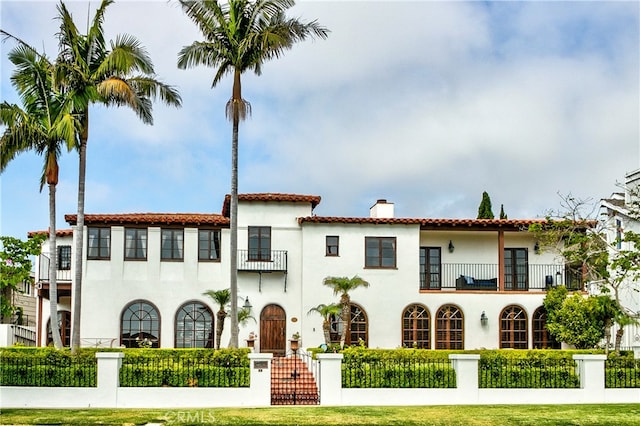 exterior space with a balcony and a front lawn