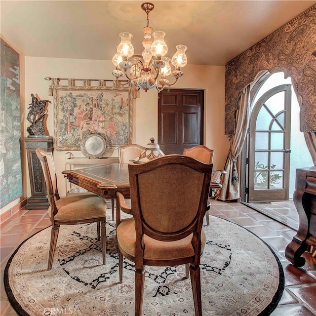 tiled dining space featuring a notable chandelier