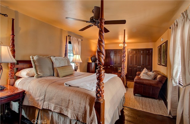 bedroom featuring ceiling fan and dark wood-type flooring