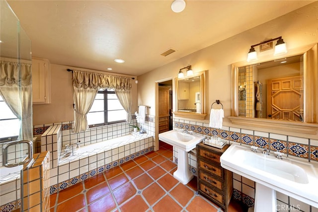 bathroom with decorative backsplash, tile patterned floors, and a washtub