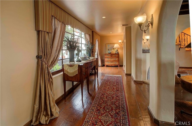 hallway with hardwood / wood-style floors