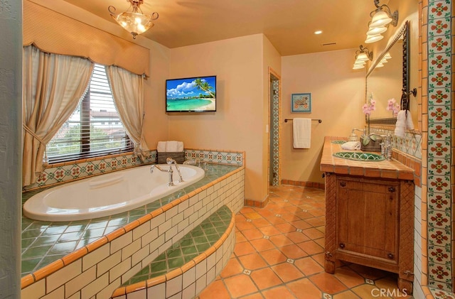 bathroom featuring vanity, tile patterned floors, and a relaxing tiled tub