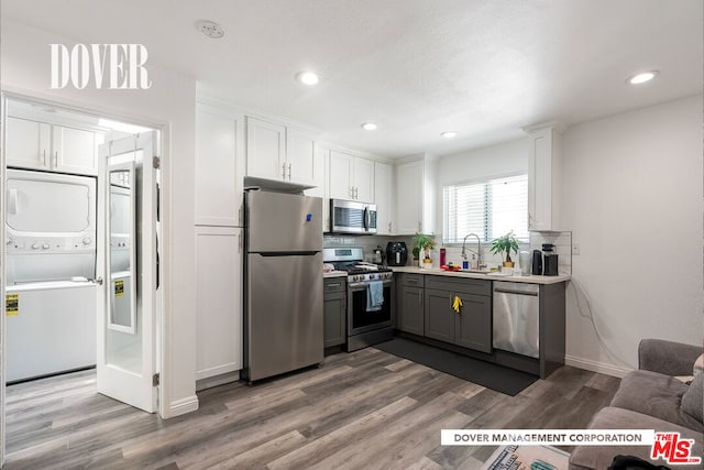 kitchen featuring appliances with stainless steel finishes, white cabinets, gray cabinets, light hardwood / wood-style flooring, and sink