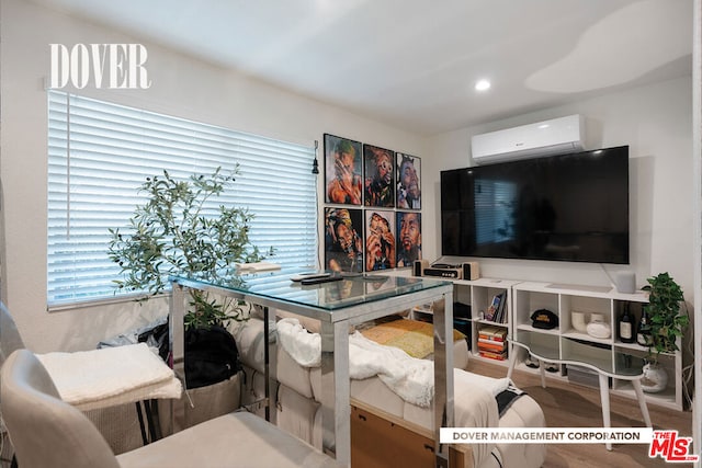 interior space with a wall unit AC and hardwood / wood-style floors